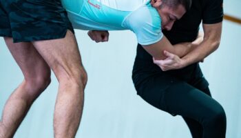 A self defense class in training, under the guidance of an instructor.